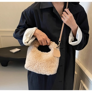 Detail of plush faux fur handbag featuring soft texture and leather shoulder strap