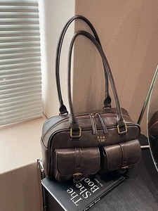 Vintage brown leather underarm bag with dual front pockets and long shoulder straps
