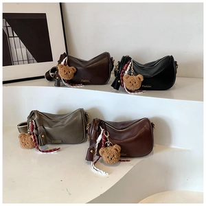 Detail view of four stylish Boston handbags in dark coffee, black, green and burgundy