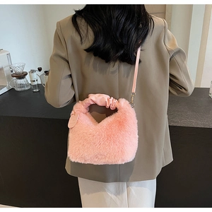 Model view of pink plush crossbody bag with ruched handle for fall winter style