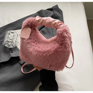 Detail of pink faux fur handbag with ruched leather handle and small branded tag