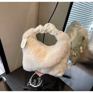 Detail of white plush faux fur handbag with cream leather ruched handle and tag
