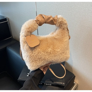 Detailed shot of plush faux fur handbag with twisted PU leather handle and shoulder strap