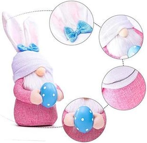 Detail view of pink Easter gnome plush with bunny ears, lilac hat and floral bow accent