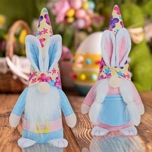 Detailed close-up of Easter gnomes featuring bunny ears and floral hats on wood
