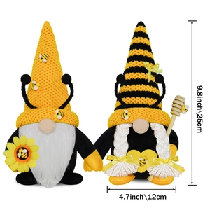 Two handmade Bee Day gnomes with sunflower and honey wand in black and yellow knits