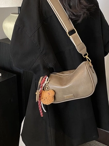 Chic brown Boston pillow bag with wide strap and cute bear charm pendant