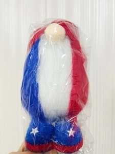 Detail of plush Patriotic Independence Day gnome doll featuring stars and stripes in polybag