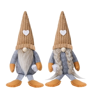 Close-up of handmade coffee-themed gnomes with knitted hats and white heart details