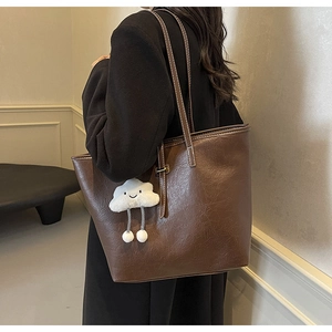 Brown tote bag in vintage faux leather with stitching and cloud plush charm detail