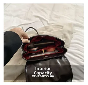 Detail view of the spacious internal capacity and red striped lining of this backpack