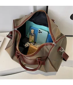 Top view of spacious interior of khaki travel bag filled with tablet and accessories