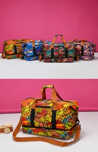 Detail view of large travel bag with tropical leaf print and bottom shoe compartment