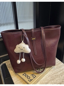 Large dark red faux leather tote bag with white cloud charm and long shoulder straps