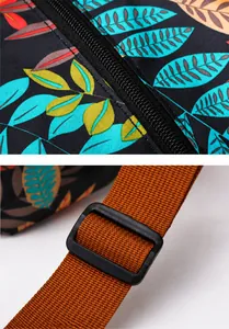 Detail view of the durable black zipper and adjustable shoulder strap on the floral travel bag