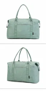 Detailed side view of light green waterproof travel bag with adjustable metal side snaps