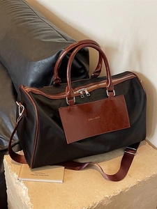 Large capacity travel tote bag in black fabric with brown leather handles and shoulder strap