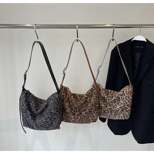 Multiple color options of leopard print tote bags shown hanging on a metal clothing rack