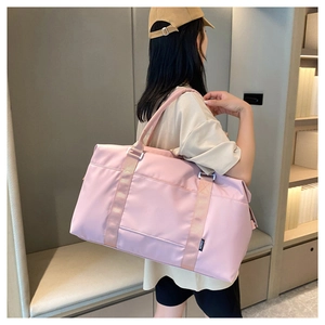 Close-up of a large capacity waterproof light pink travel bag showing smooth nylon texture