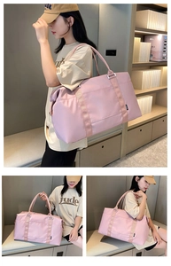 Pink waterproof travel duffel bag with durable shoulder straps and metal hardware