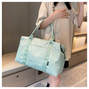 Spacious mint green waterproof travel bag with Hongz logo label shown on model