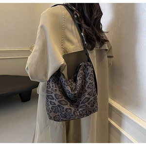 Leopard print tote bag styled with a khaki trench coat for a vintage autumn look