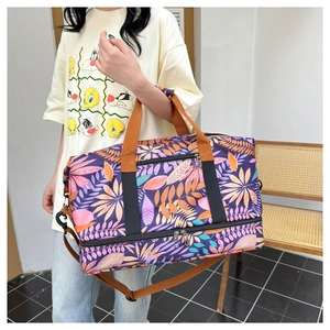 Détail du sac de voyage à motif feuilles tropicales avec fermeture éclair et poignées