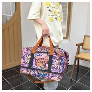 Gros plan du grand sac de voyage violet à motif tropical et compartiment à chaussures séparé