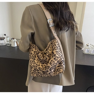 Detail of wide adjustable shoulder strap on large leopard print hobo bag with silver buckle