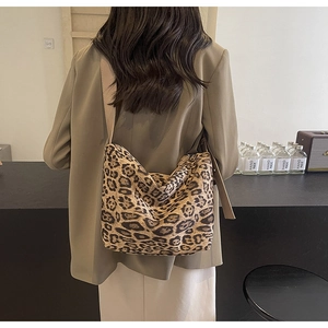 Leopard print tote bag detail showing wide brown strap and high-density fabric texture