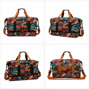 Macro detail of red tropical leaf print travel bag with reinforced handles and strap