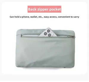 Vue détaillée de la poche zippée arrière du sac de voyage vert montrant le téléphone