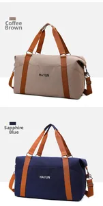 Detail view of large yoga travel bags in coffee and royal blue with sturdy nylon handles