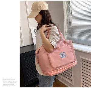 Pink large travel bag with expandable bottom layer and dedicated shoe compartment