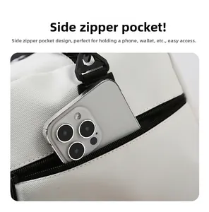 Detail of the side zipper pocket on a white waterproof gym bag for phone and wallet storage