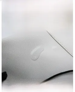 Detail showing water-resistant oxford fabric texture with beads of water on surface