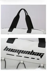 Detail of durable white fitness bag with reinforced black handles and logo