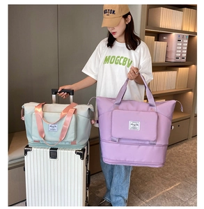 Travel bag with trolley sleeve being attached to a silver suitcase for easy transport