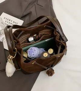 Interior view of brown suede bucket bag showing spacious capacity and striped lining