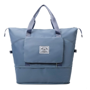Vista frontal de la bolsa de viaje oxford azul gris con compartimento para zapatos y asas
