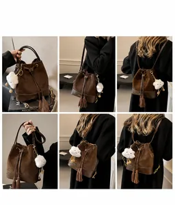 Detailed views of a bucket bag featuring suede leather contrast and plush cloud charm