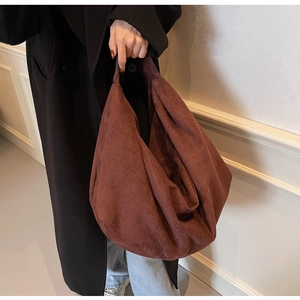 Detail of soft brown suede texture and spacious interior of the relaxed tote bag