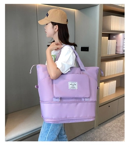 Detail view of large purple travel bag with front pocket and expandable bottom layer