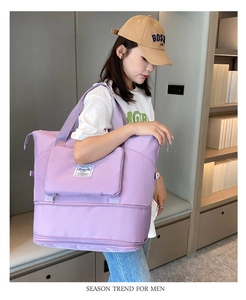 Side view of a purple waterproof travel bag with bottom expansion layer on a female model