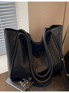 Large black leather tote bag with pleated texture and dual straps for women's daily commute