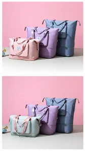 Detail of multi-colored large capacity travel duffel bags with waterproof fabric and carry handles