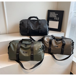 Three high-capacity Oxford cloth travel bags in black, green, and grey on marble stairs
