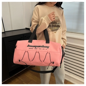 Pink waterproof fitness bag with detachable strap and stylish crisscross rope detail