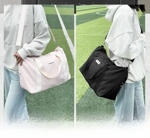Detail of bubble texture travel bag with reinforced straps and detachable hook