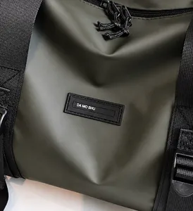 Macro shot of waterproof olive green Oxford fabric texture and brand rubber logo